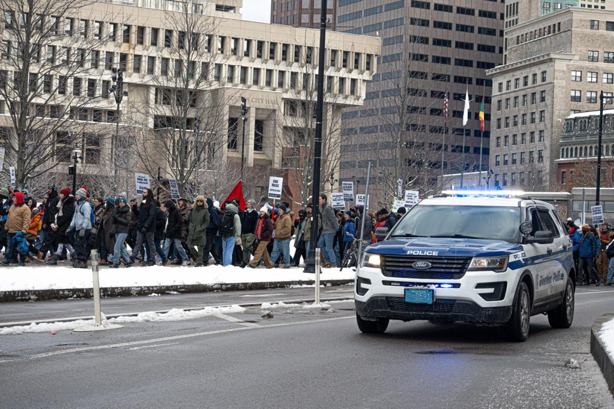  A police car blocks a march for Massachusetts to become a sanctuary state near Boston City Hall Sunday, Feb. 9. 