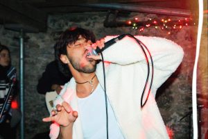 Arizona Barahona Bueso singing at one of Nicks House's performances. 