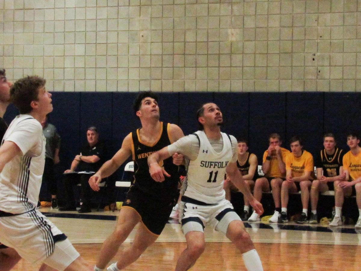 Senior forward Keenan Robertson and Wentworth guard Jack Connell jockeying for position during a Feb. 25 game.