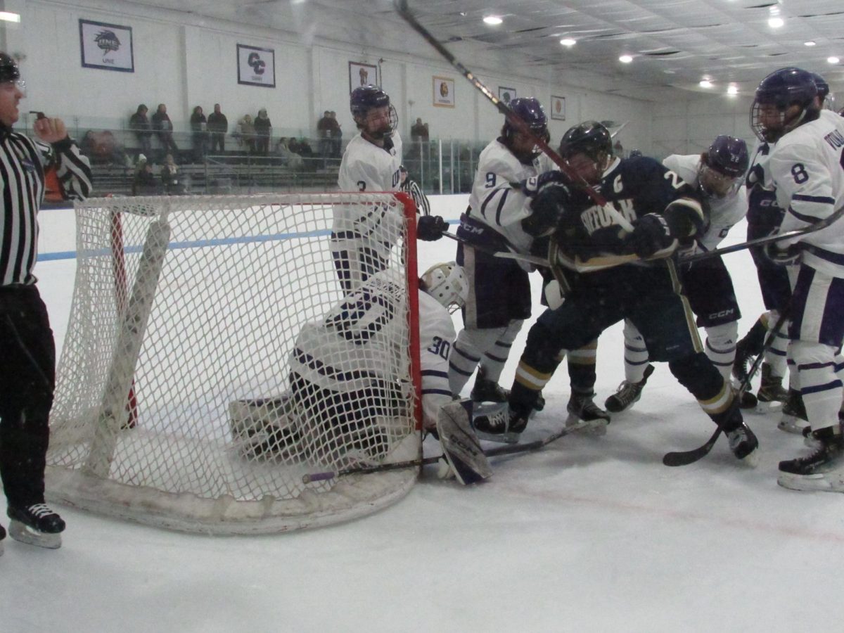 Suffolk and Curry players get into a scuffle in front of Curry goaltender Shane Soderwall Feb. 1.