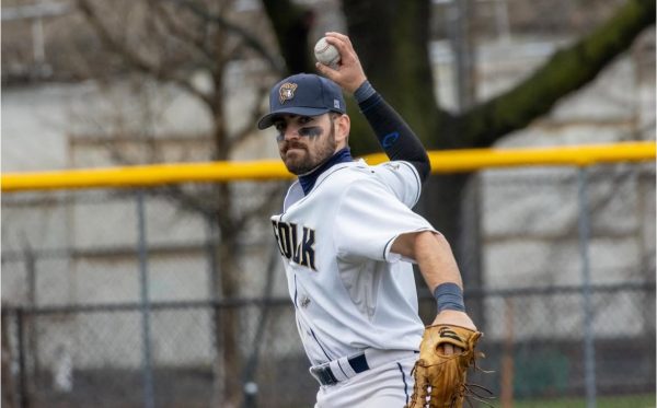Alex Sorenti-Burns throwing the ball during a home game against Nichols College April 6 (courtesy of Sophia DiNanno).