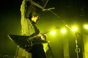 Pierce the Veil's Vic Fuentes rocking out on stage at Xfinity Center. 