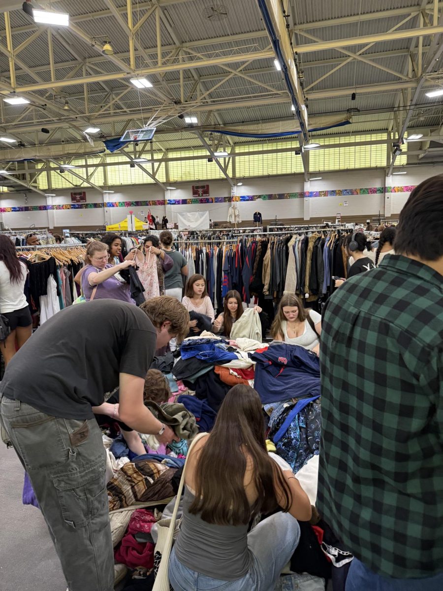 Thrifters going through a pile of vintage clothes at Select Markets’ back to school event in Roxbury. 