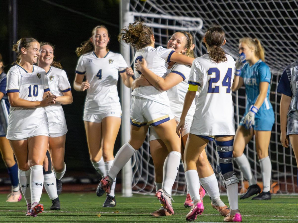Players from the Suffolk women's soccer team celebrate after scoring a goal during a 5-0 win over Rivier University at home.