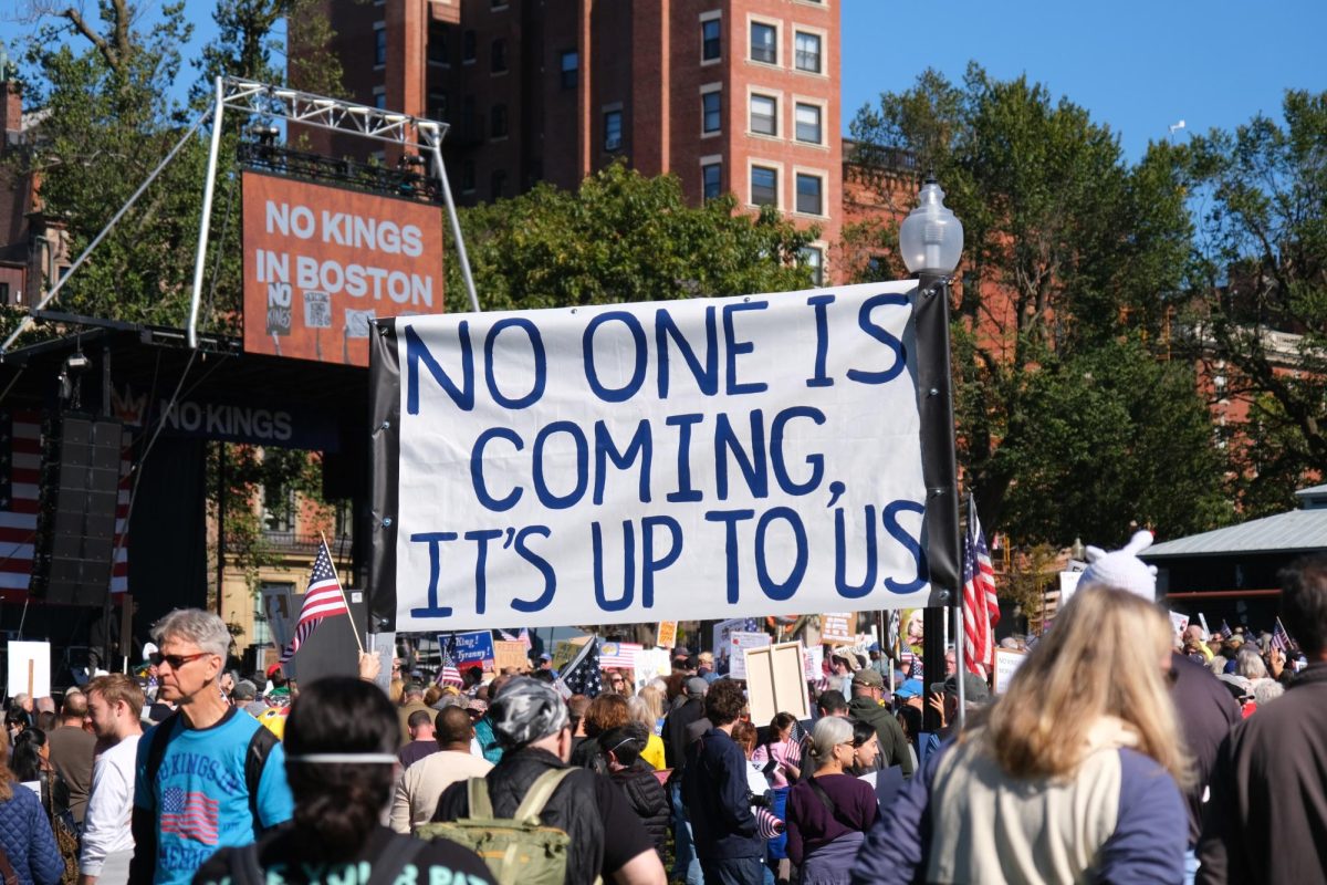 Protesters hold sign during "No Kings" protest in Boston Common Oct. 18. 
