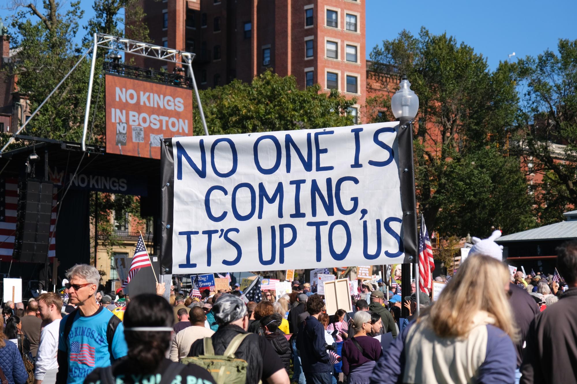 Protesters hold sign during "No Kings" protest in Boston Common Oct. 18. 