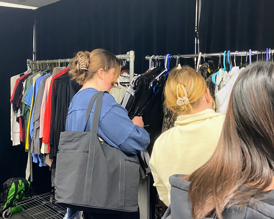 Students browsing Suffolk’s Performance and Arts Council, Thrift-o-RAMa and the WSFR collaborative campus costume sale racks.