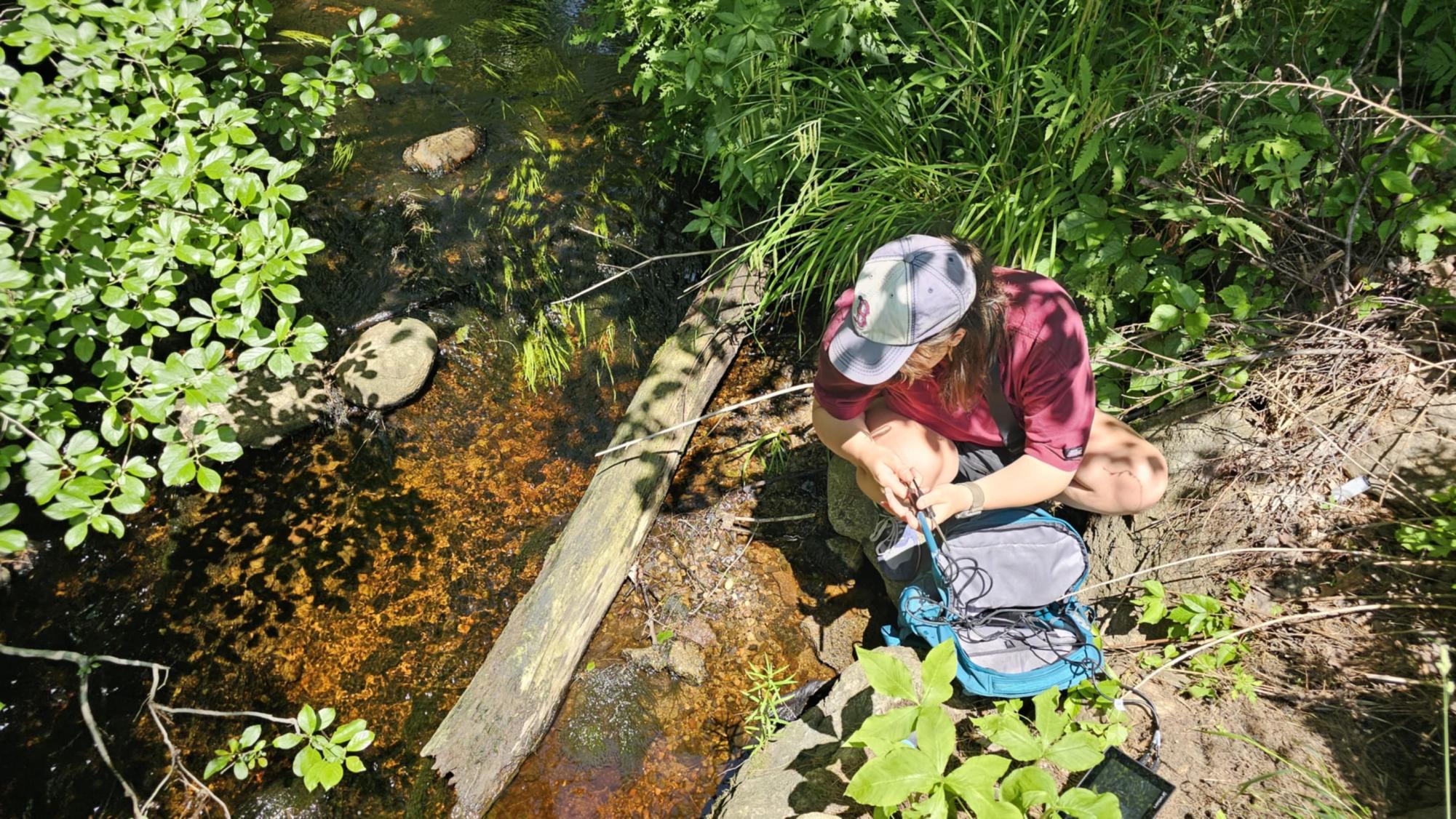 Ella Weinmann collecting water samples for her research. Courtesy of Ella Weinmann.