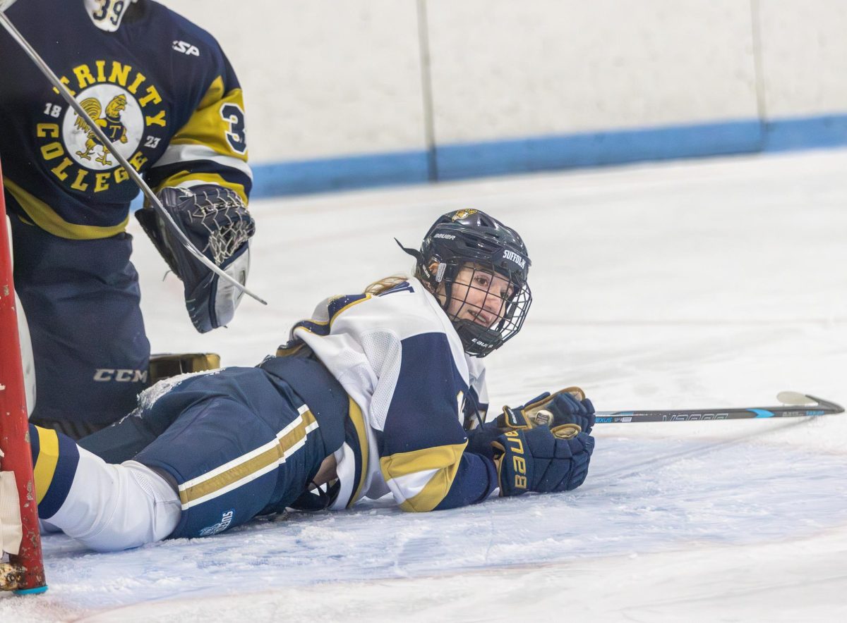 Bella Schmidt after falling to the ice during a loss to Trinity College.