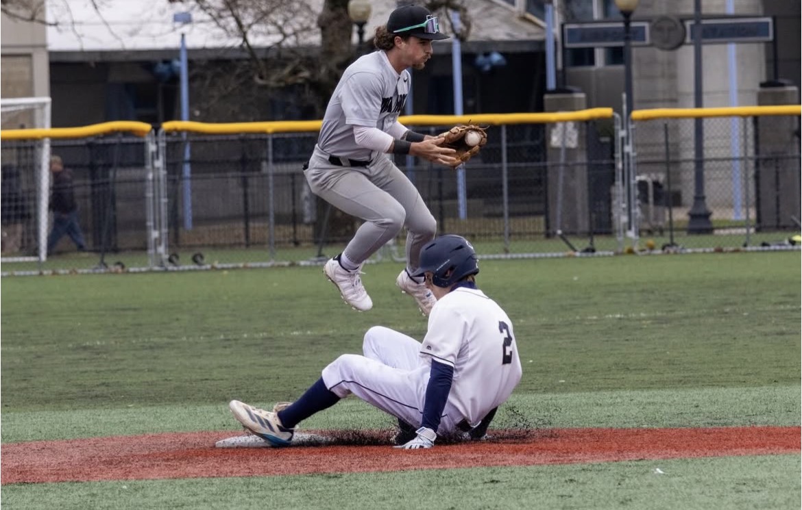 Cole Hilliard slides into second base after a hit during a doubleheader against Nichols College April 6, 2025.
