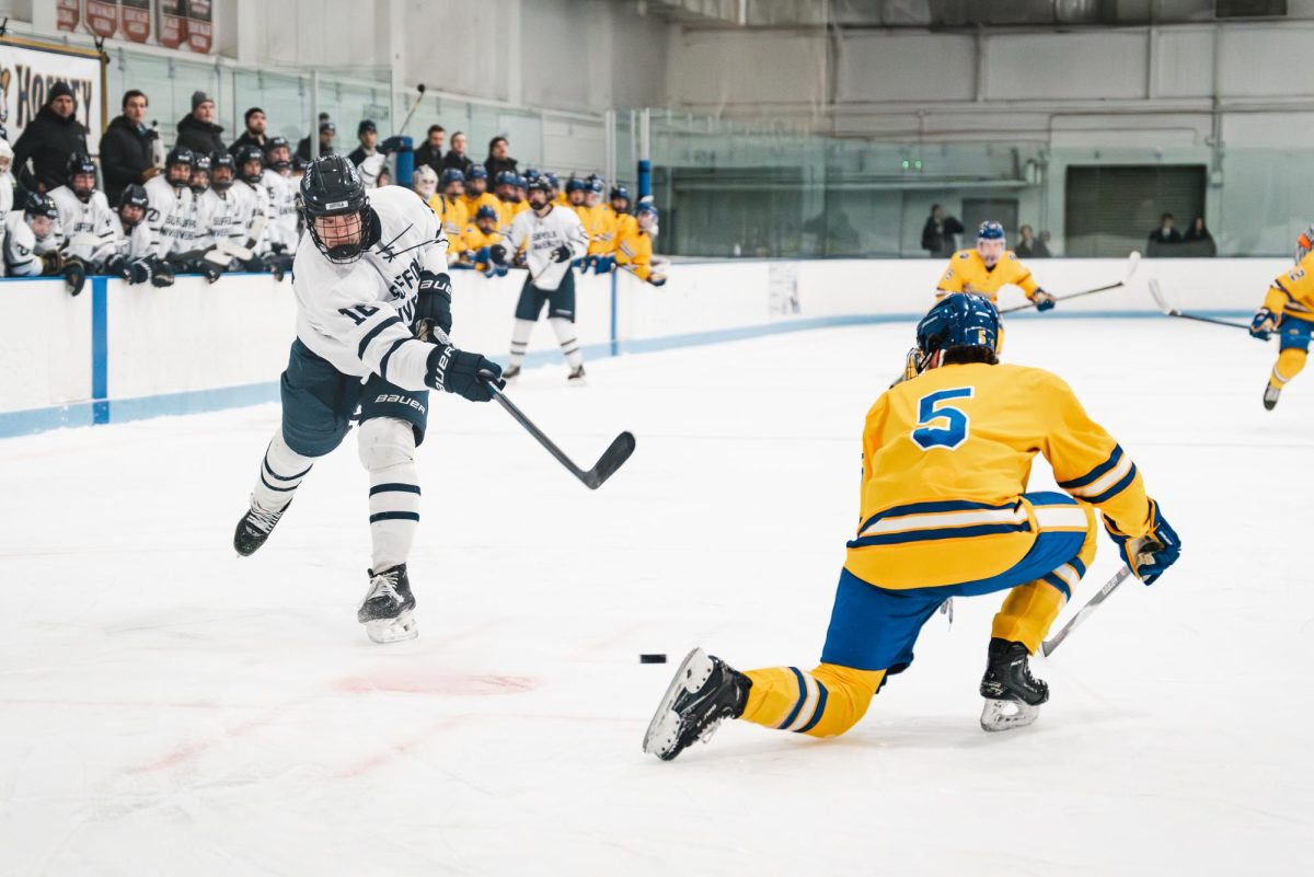 Freshman forward Alex Ondos taking a shot through traffic during a Jan. 24 game against Johnson & Wales University.