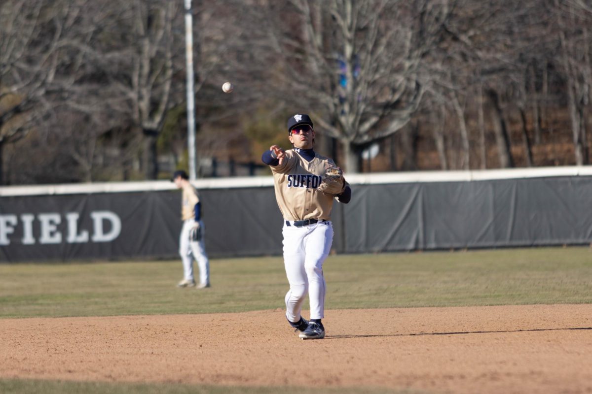 Second baseman Luke Thornton throwing the ball to first base during a March 25 game against Babson College.
