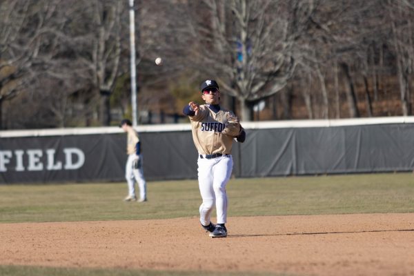 Second baseman Luke Thornton throwing the ball to first base during a March 25 game against Babson College.