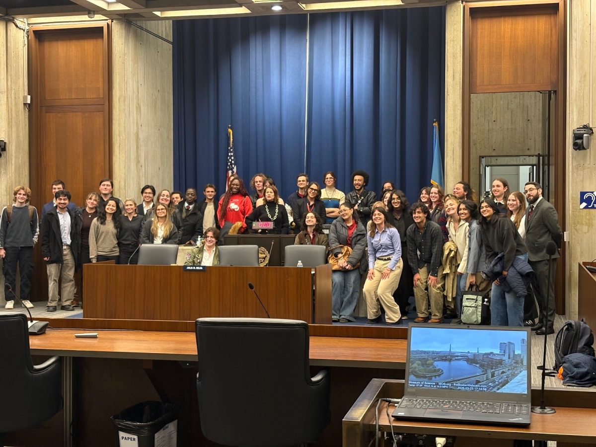 Attendees at the Boston City Council hearing posed with Councilor Julia Mejia. 